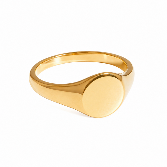 A polished yellow gold signet ring with a flat oval face, shown on a clean white background.